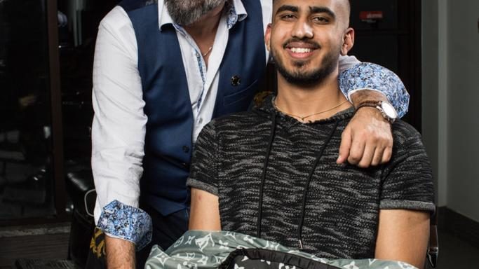 Sam with a young client after a haircut